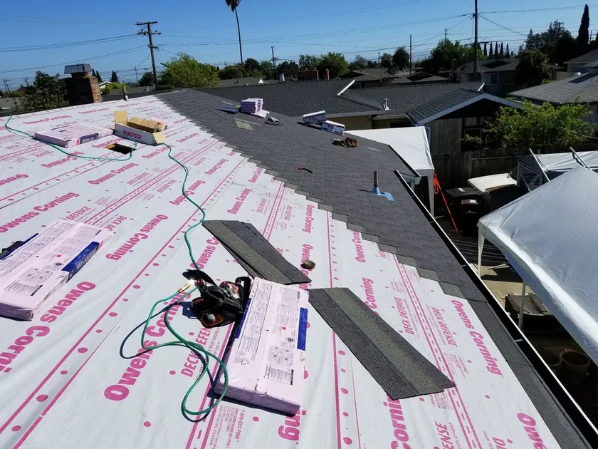 Underlayment going down across a stripped roof deck