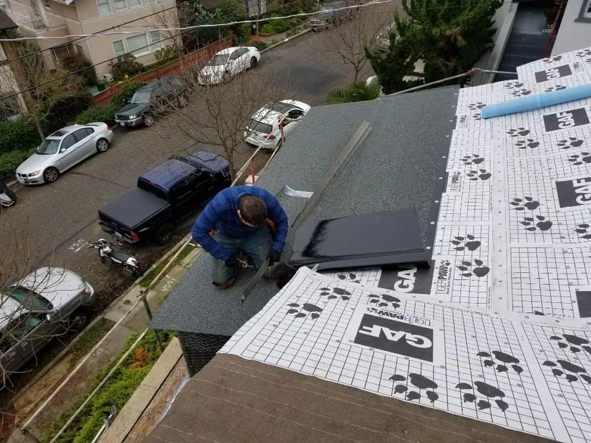 Roofing crew working across a roof in progress