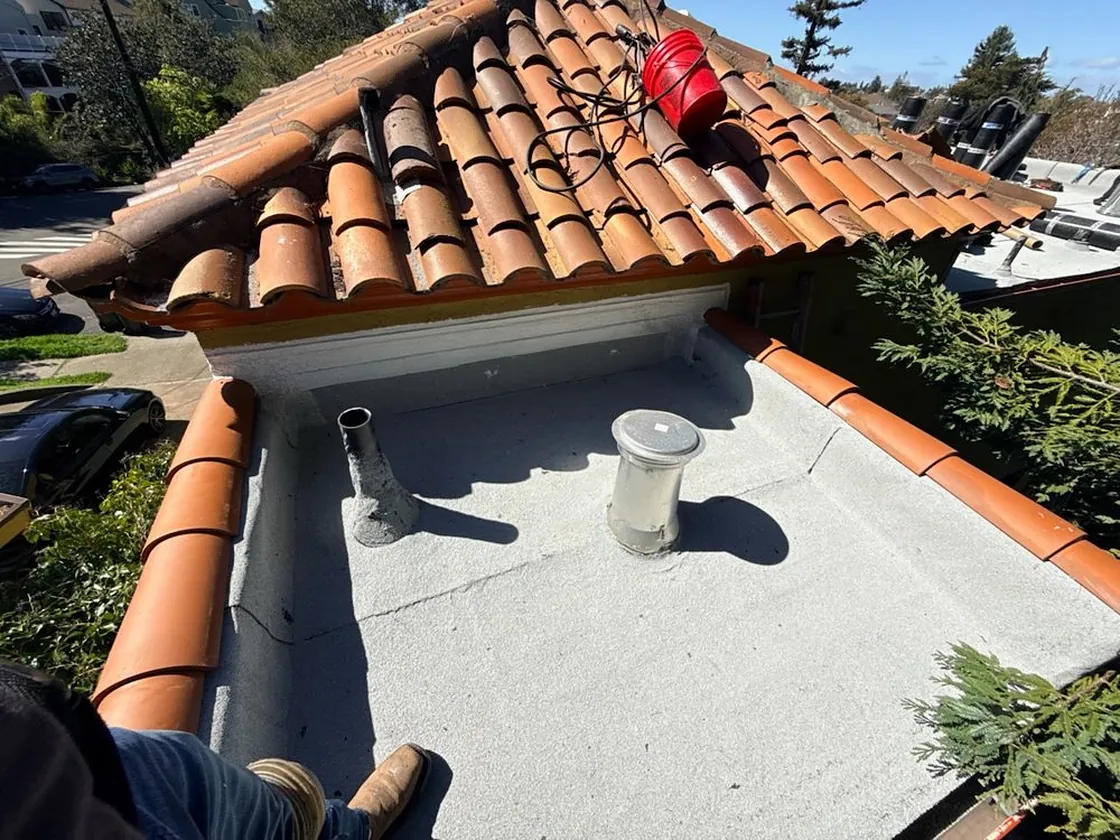 Terracotta tile roof ridge with vents and finished flashing detail